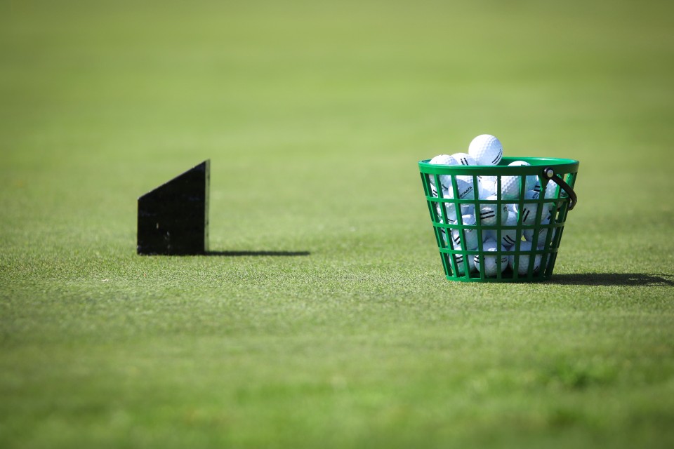 cart of golf balls waiting to be used